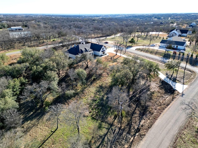 birds eye view of property featuring a view of trees