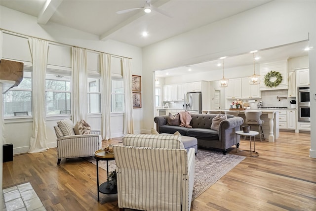 living area with baseboards, ceiling fan, light wood-type flooring, beam ceiling, and recessed lighting