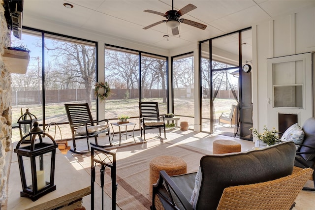 sunroom / solarium featuring ceiling fan