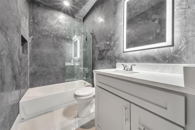 full bath with tile walls, toilet, bathing tub / shower combination, and vanity