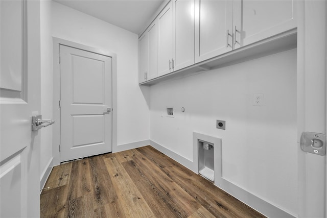 clothes washing area with washer hookup, dark wood finished floors, cabinet space, hookup for an electric dryer, and baseboards