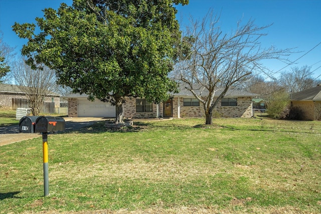 view of front facade with a garage, a front lawn, and brick siding