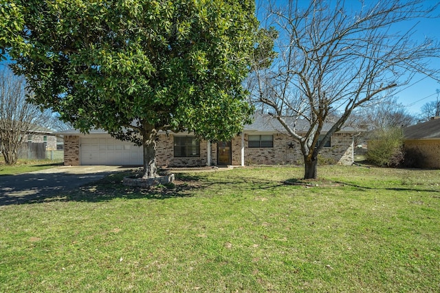 view of front of property with an attached garage, driveway, brick siding, and a front yard