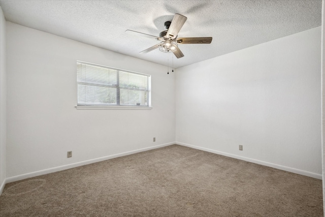 carpeted empty room with baseboards, a ceiling fan, and a textured ceiling