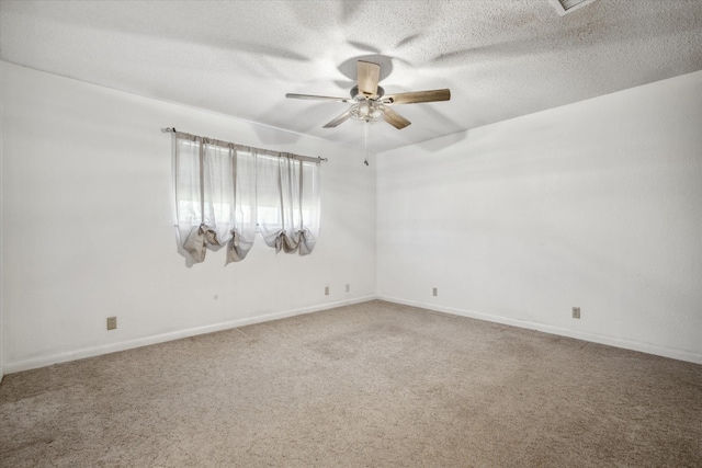 empty room with a textured ceiling, ceiling fan, carpet flooring, and baseboards