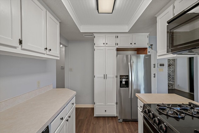 kitchen with dark wood-style floors, a raised ceiling, white cabinets, and black appliances