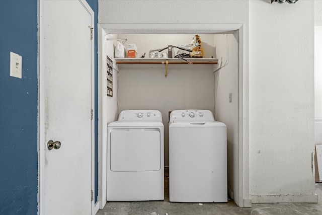 clothes washing area featuring laundry area and washer and dryer