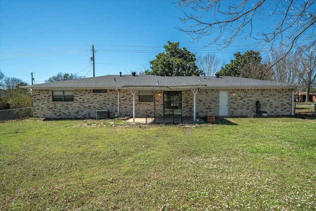 back of property with brick siding, a patio, a lawn, fence, and cooling unit