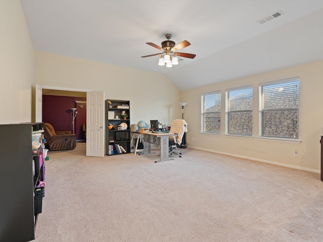 home office with carpet, visible vents, a ceiling fan, vaulted ceiling, and baseboards