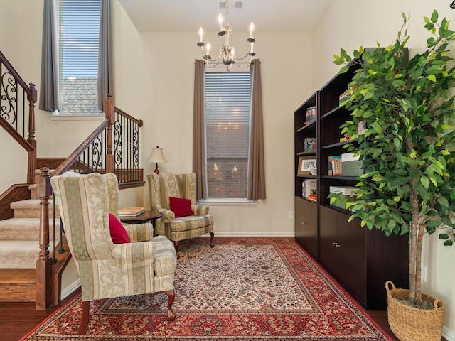 living area featuring an inviting chandelier, stairway, and a wealth of natural light