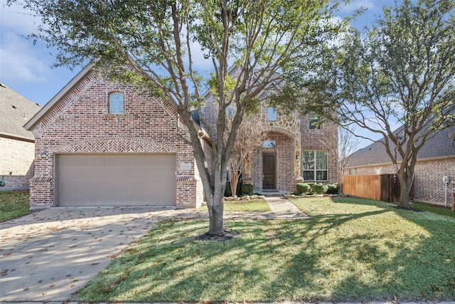 view of front facade with driveway, an attached garage, fence, a front lawn, and brick siding