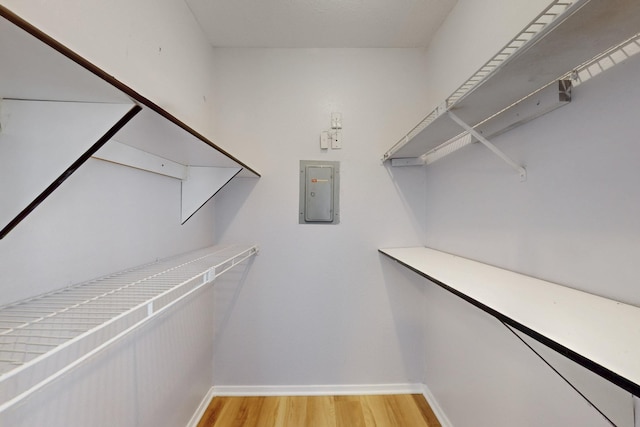 spacious closet featuring light wood-style floors and electric panel