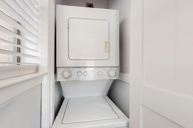 laundry area featuring stacked washing maching and dryer and laundry area