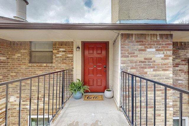 doorway to property with brick siding