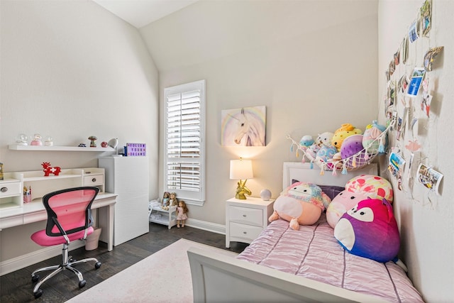 bedroom with baseboards, vaulted ceiling, and wood finished floors