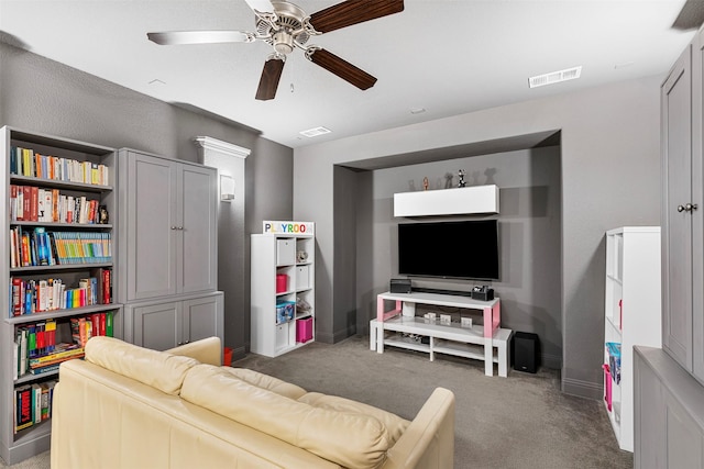 living area with baseboards, visible vents, ceiling fan, and carpet flooring