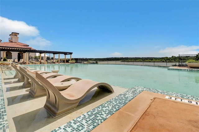 community pool featuring a patio, fence, and a pergola