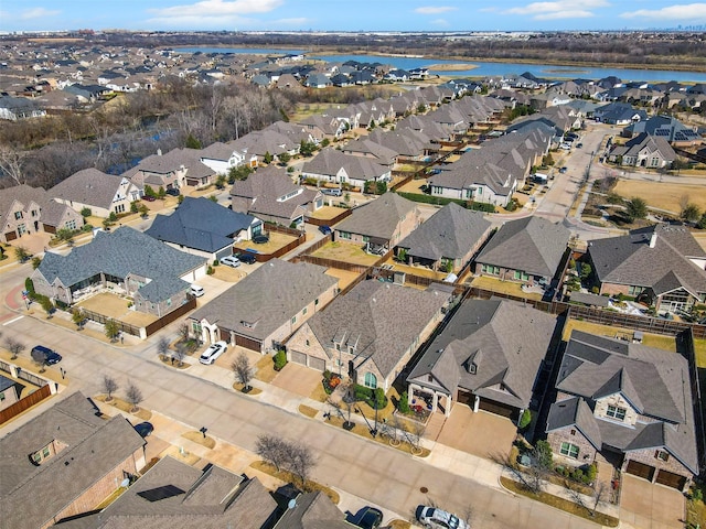 drone / aerial view featuring a water view and a residential view