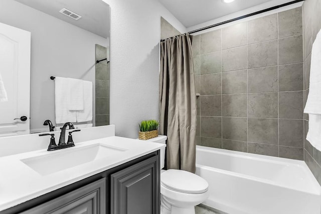 full bath featuring visible vents, toilet, shower / bath combo, and vanity