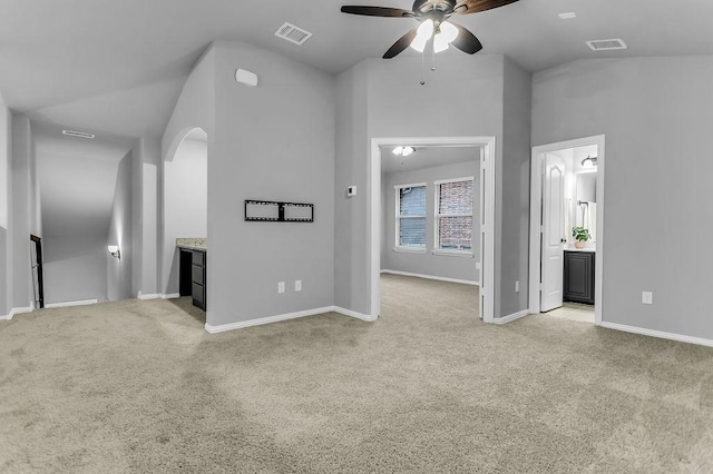 unfurnished living room with visible vents, light colored carpet, and a ceiling fan