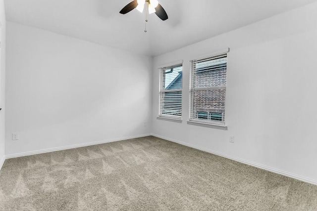 unfurnished room featuring baseboards, carpet floors, and a ceiling fan