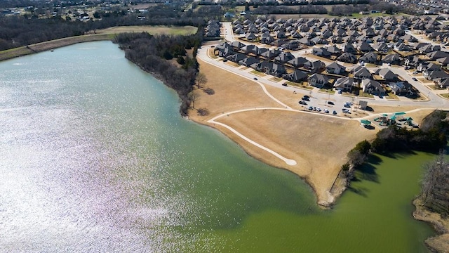 drone / aerial view featuring a residential view and a water view