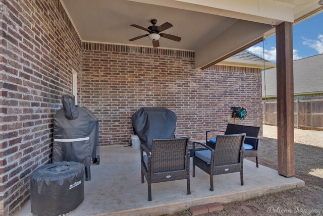 view of patio / terrace featuring ceiling fan, fence, and a grill