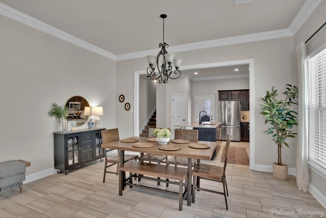 dining space with ornamental molding, stairway, baseboards, and an inviting chandelier