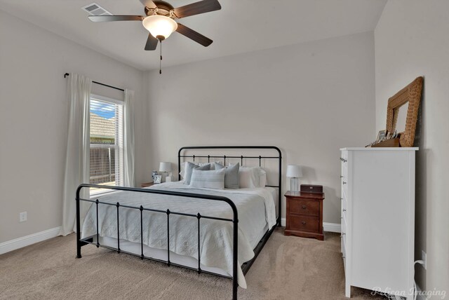 bedroom with carpet floors, baseboards, visible vents, and ceiling fan