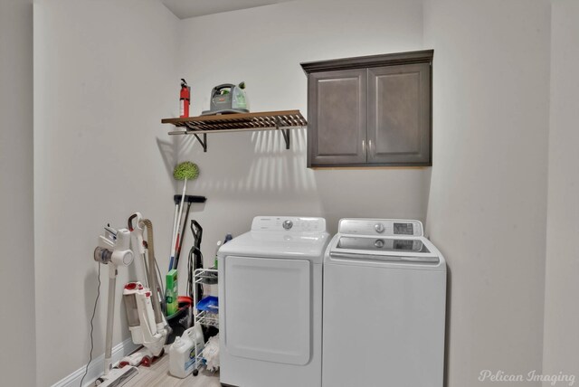 laundry area featuring cabinet space, independent washer and dryer, and baseboards