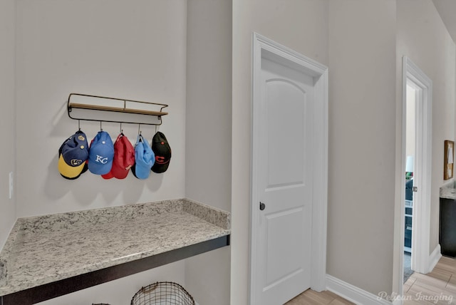 mudroom with light wood-style floors and baseboards