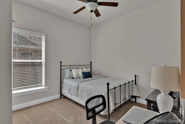 bedroom with ceiling fan, baseboards, and carpet flooring