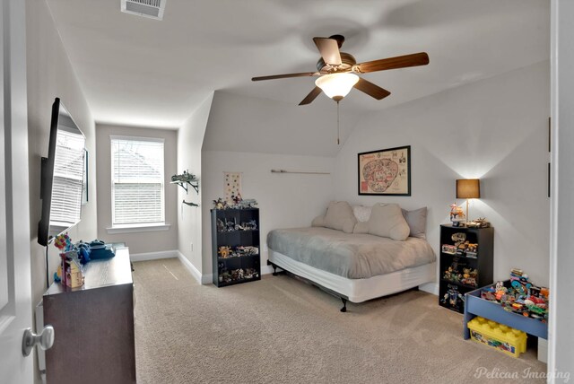 carpeted bedroom featuring a ceiling fan, lofted ceiling, visible vents, and baseboards