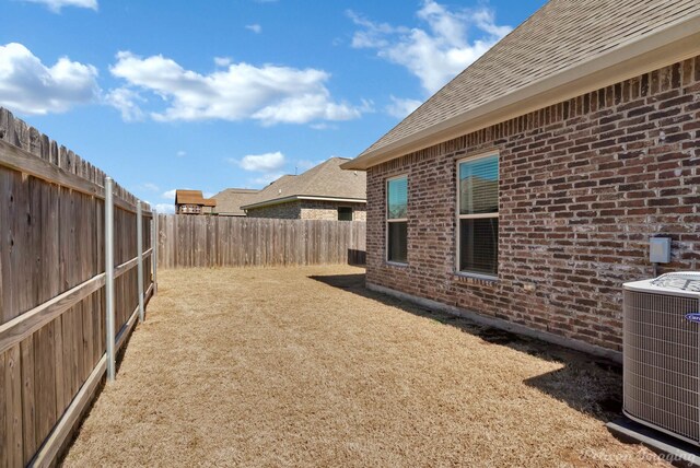 view of yard with cooling unit and a fenced backyard