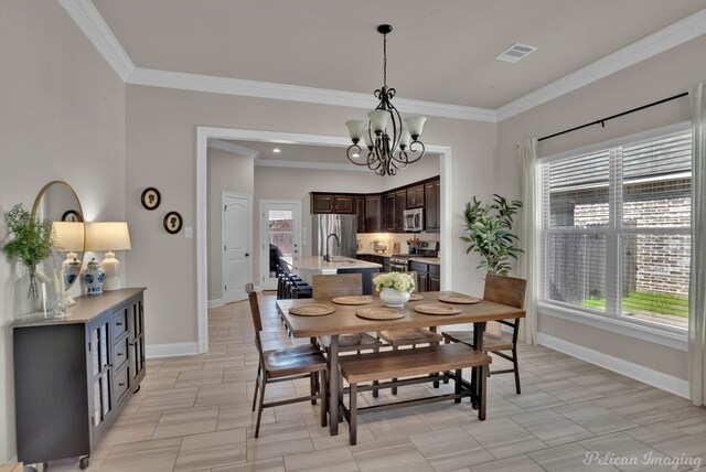 dining area with a wealth of natural light, baseboards, visible vents, and a notable chandelier