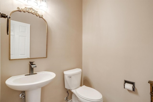 bathroom featuring toilet and a sink