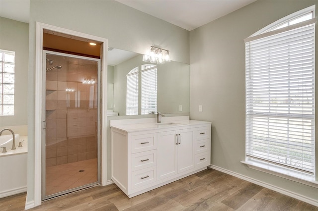 full bath with plenty of natural light, wood finished floors, and a shower stall