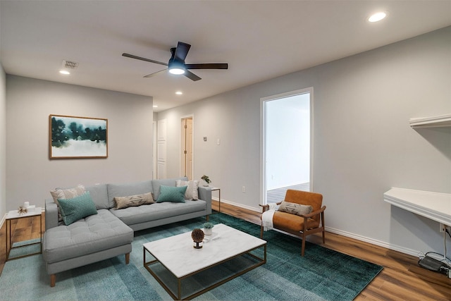 living room with visible vents, baseboards, wood finished floors, and recessed lighting