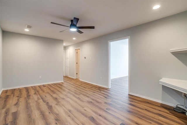 unfurnished living room with baseboards, wood finished floors, a ceiling fan, and recessed lighting