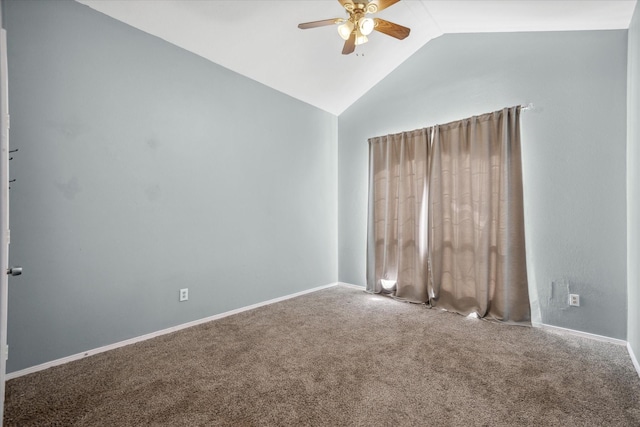 carpeted empty room with lofted ceiling, ceiling fan, and baseboards