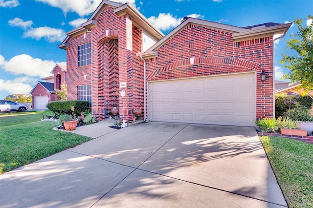 traditional-style house with a front yard, concrete driveway, brick siding, and an attached garage