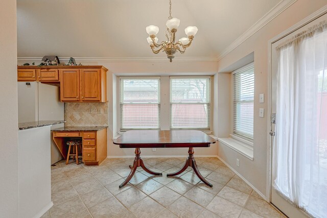 dining area with ornamental molding, lofted ceiling, a notable chandelier, and baseboards