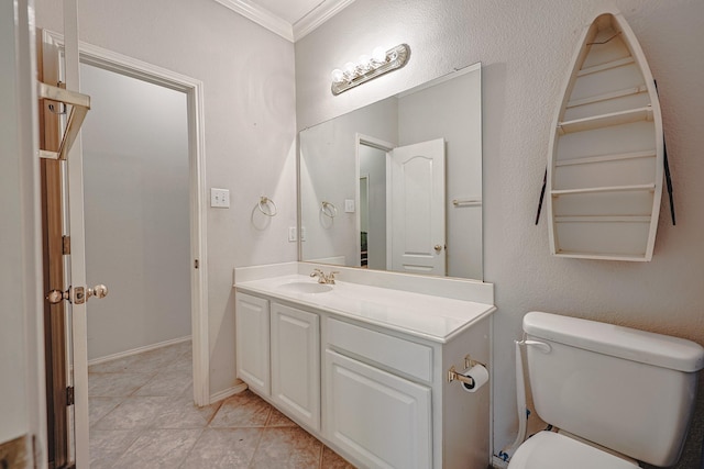 bathroom with toilet, vanity, baseboards, tile patterned floors, and crown molding