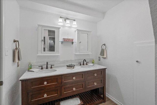 2412 Cedar Crest Dr, Granbury, TX 76048 - full bathroom with wood finished floors, double vanity, and a sink