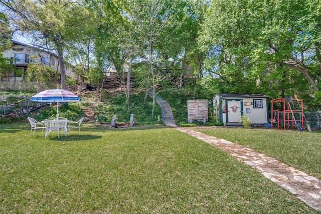 2412 Cedar Crest Dr, Granbury, TX 76048 - view of yard featuring a shed, a playground, and an outdoor structure