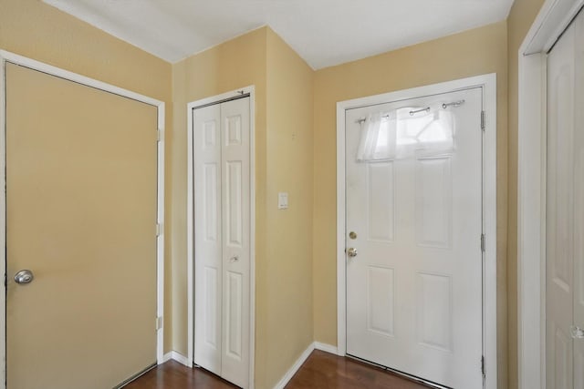 entrance foyer featuring dark wood-style floors and baseboards