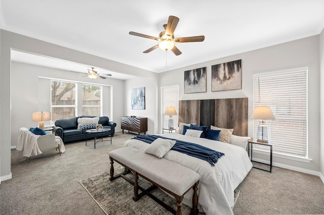 carpeted bedroom featuring baseboards, a ceiling fan, and ornamental molding