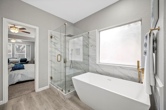 ensuite bathroom featuring a soaking tub, connected bathroom, a marble finish shower, and wood finished floors