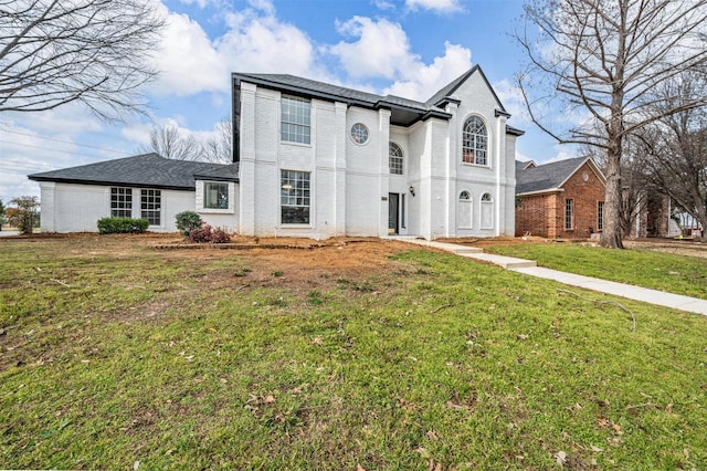 view of front of house featuring a front yard and brick siding