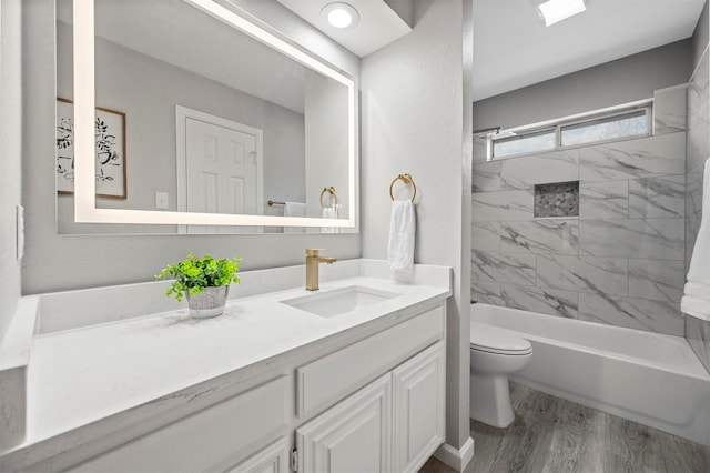 full bath featuring shower / bathtub combination, vanity, toilet, and wood finished floors